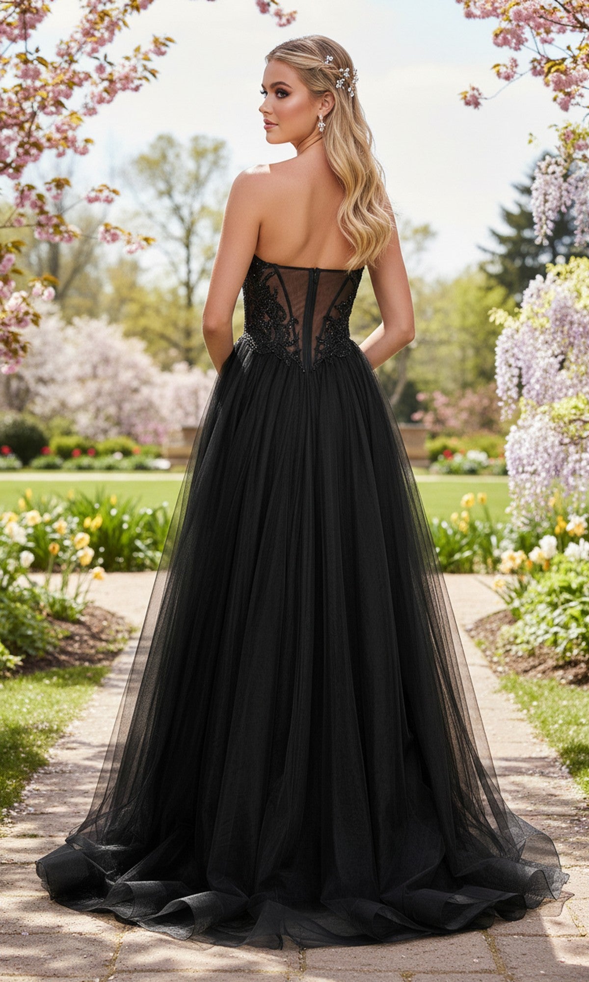 Wearing the La Femme 33410 long prom dress with a strapless beaded corset bodice and tulle A-line skirt, a woman stands on a garden path amid blooming trees and flowers.